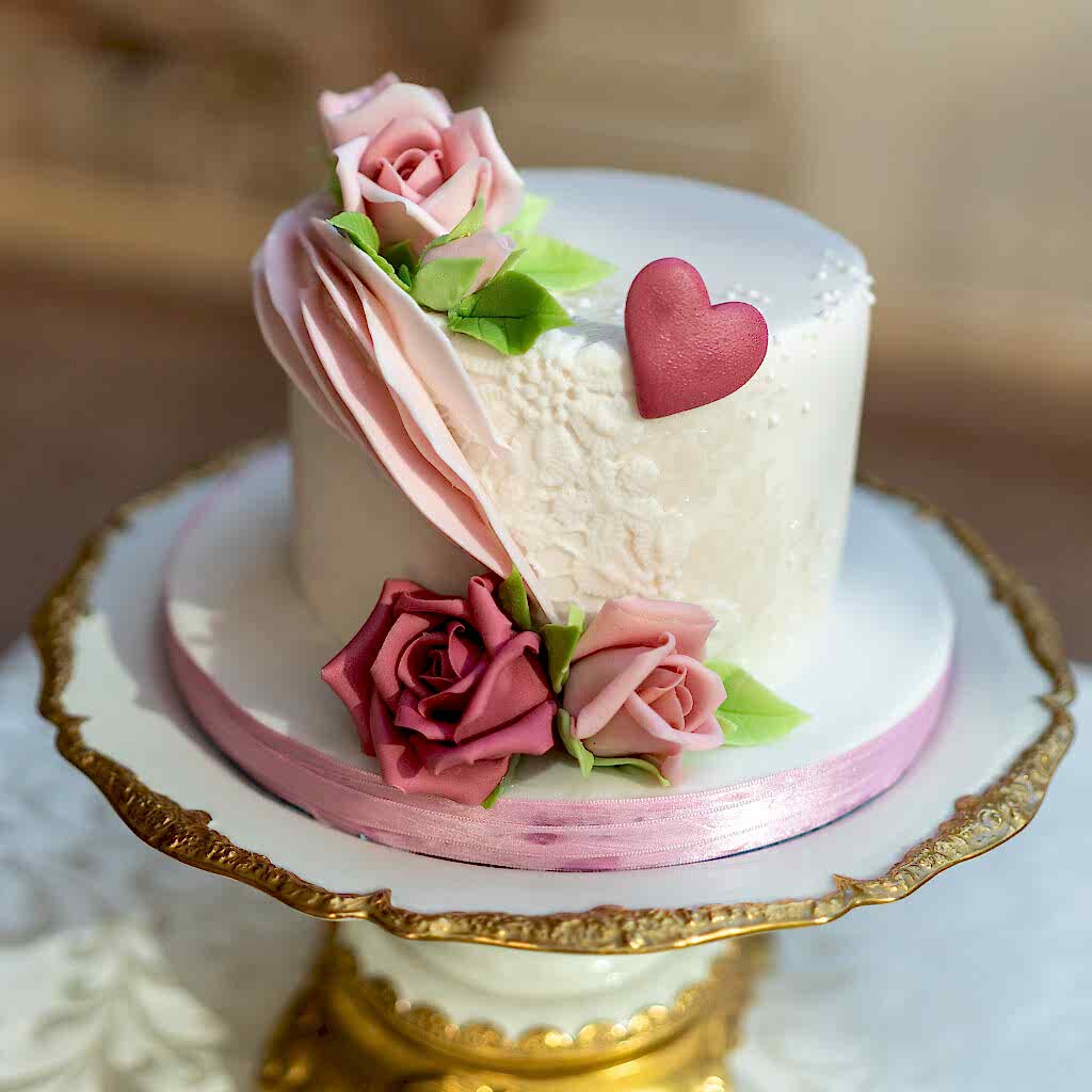 White cake with purple roses.